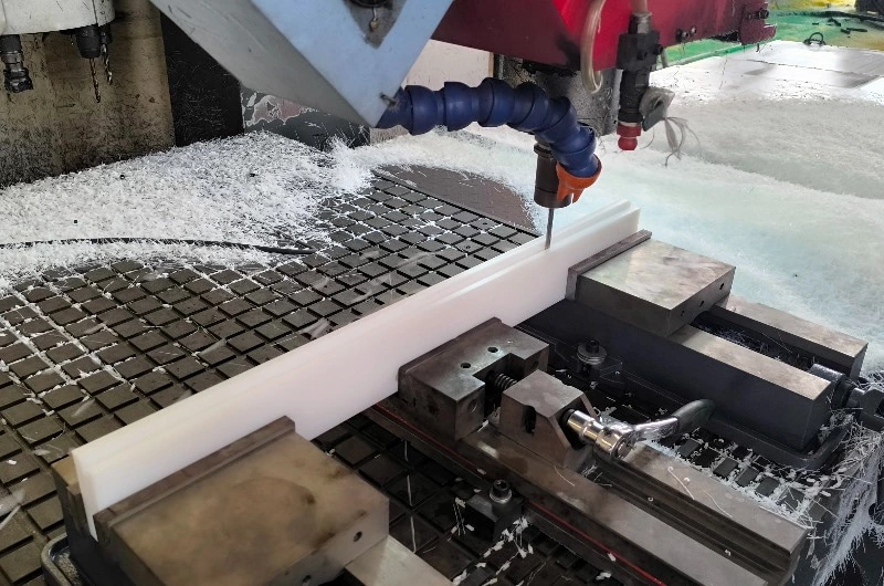 UHMWPE block mounted on CNC machine with machined edges and smooth finish