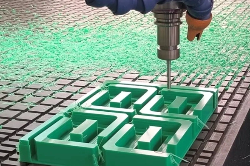 UHMW plastic block being machined on CNC tool with stringy chip formation
