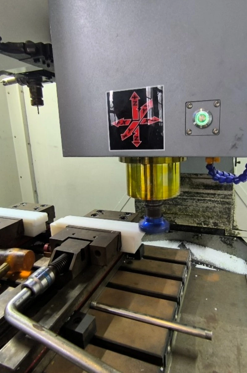 UHMWPE plastic block secured with distributed clamping on CNC fixture